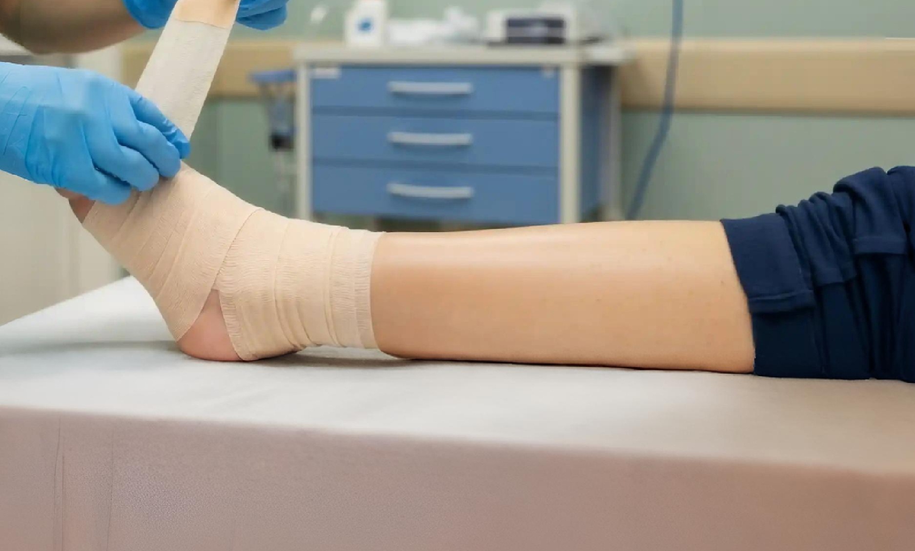 Patient receiving a supportive ankle wrap at Foot & Ankle Center of Arizona for injury recovery. 