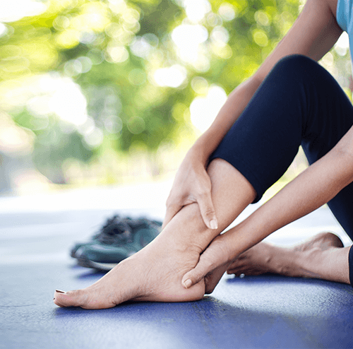 Patient experiencing ankle discomfort, highlighting the importance of specialized foot care at Foot & Ankle Center of Arizona.