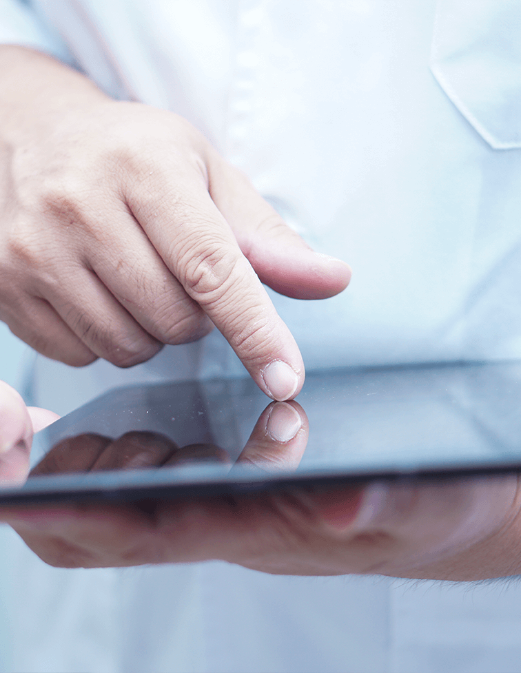 Healthcare professional using a tablet to access patient information at Foot & Ankle Center of Arizona.