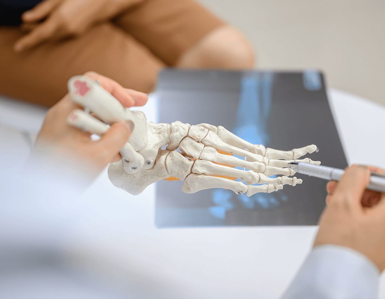 Patient consultation at Foot & Ankle Center of Arizona, focusing on foot anatomy and X-ray analysis for effective treatment.